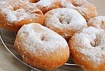 fried-donuts-in-powdered-sugar-closeup-100165320